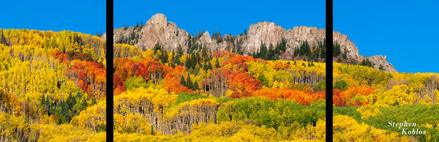 Mountains with green yellow orange and red aspens.
