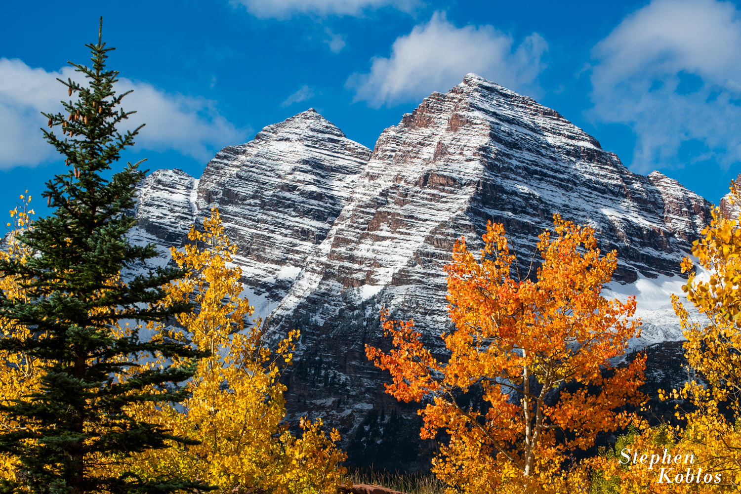 Maroon Bells in the fall with snow.
