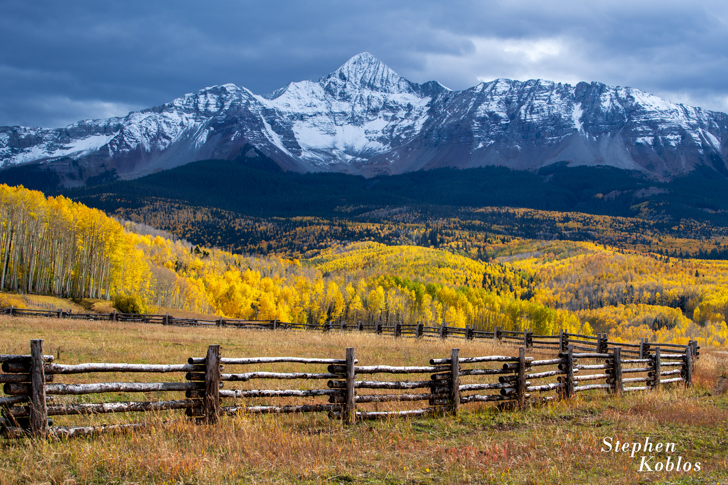 Wilson Peak in the fall under stormy clouds.